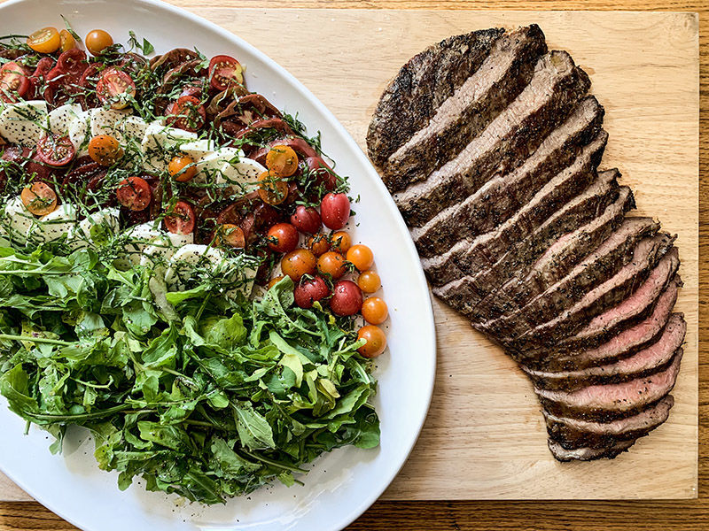 Grilled flank steak with heirloom tomatoes, arugula and mozzarella